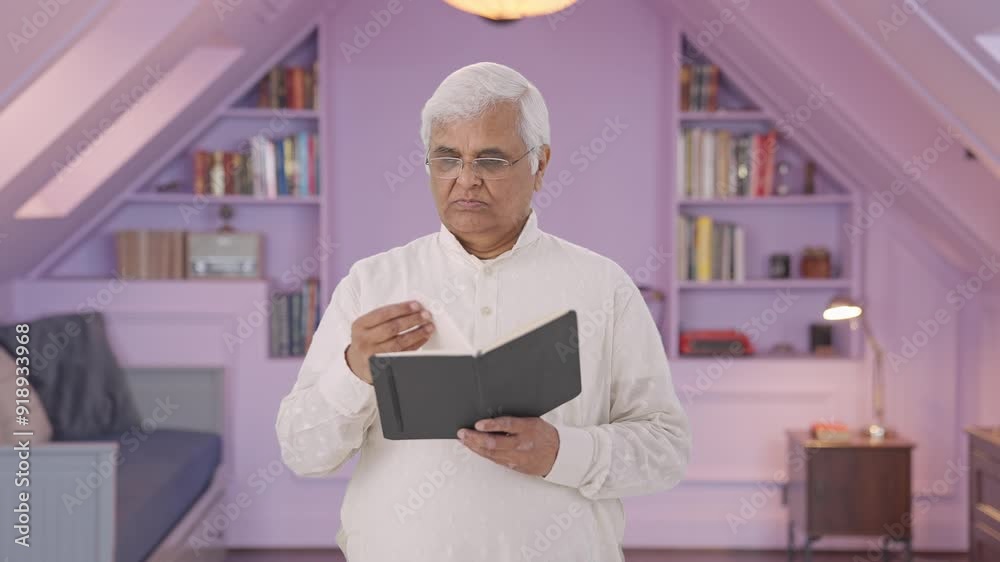 Confused Indian old man reading a book Confused Indian old man reading a book