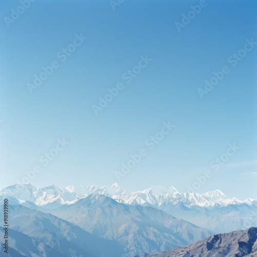 Snow-capped mountains against a clear blue sky.