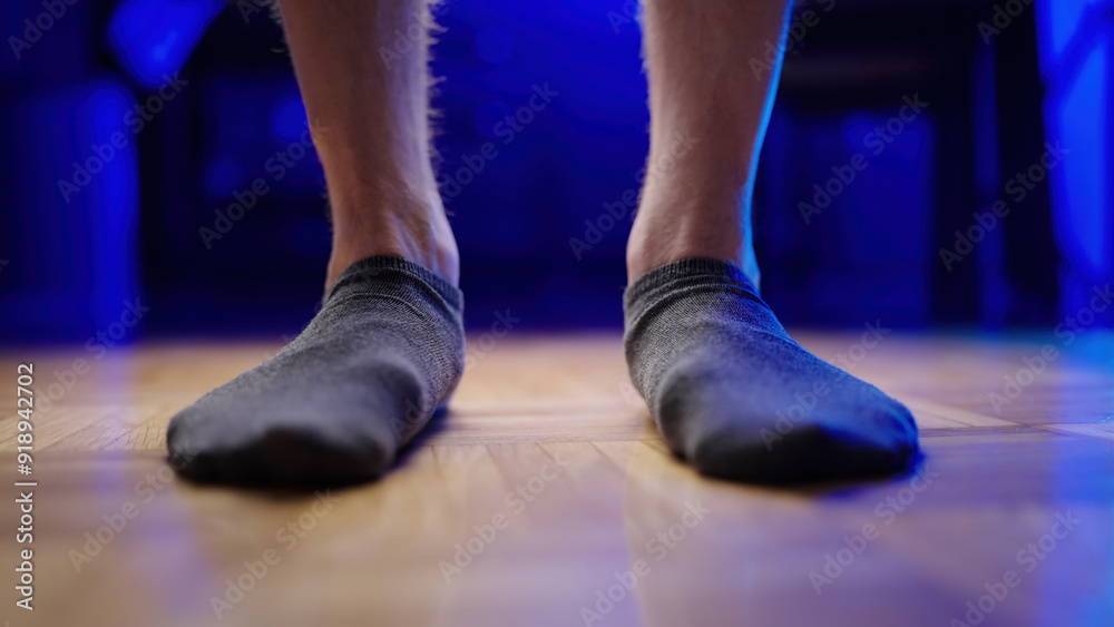 Flat feet with relaxed arch wearing gray socks close-up Flat feet with relaxed arch wearing gray socks close-up