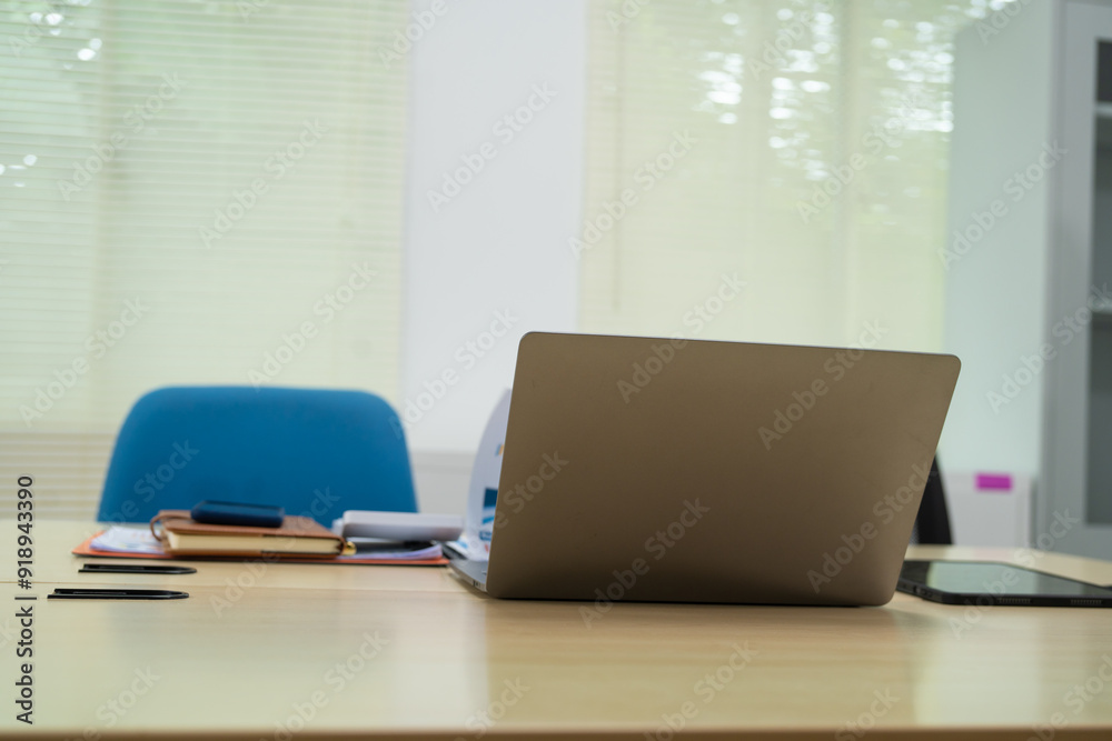 An executive work desk sits in an office, meticulously arranged with documents and office supplies. The space is empty, awaiting the return of the executive to resume daily business activities. An executive work desk sits in an office, meticulously arranged with documents and office supplies. The space is empty, awaiting the return of the executive to resume daily business activities.