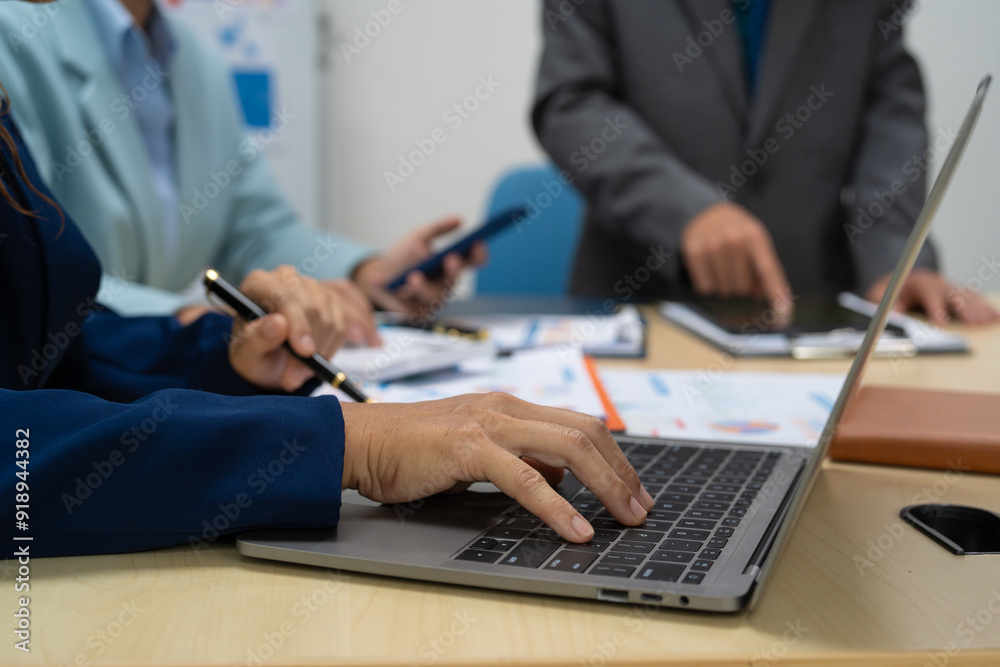 A businessperson financial analyst during a corporate meeting. review a graph document, discussing financial data and strategies to ensure successful outcomes effective teamwork achieving corporate A businessperson financial analyst during a corporate meeting. review a graph document, discussing financial data and strategies to ensure successful outcomes effective teamwork achieving corporate