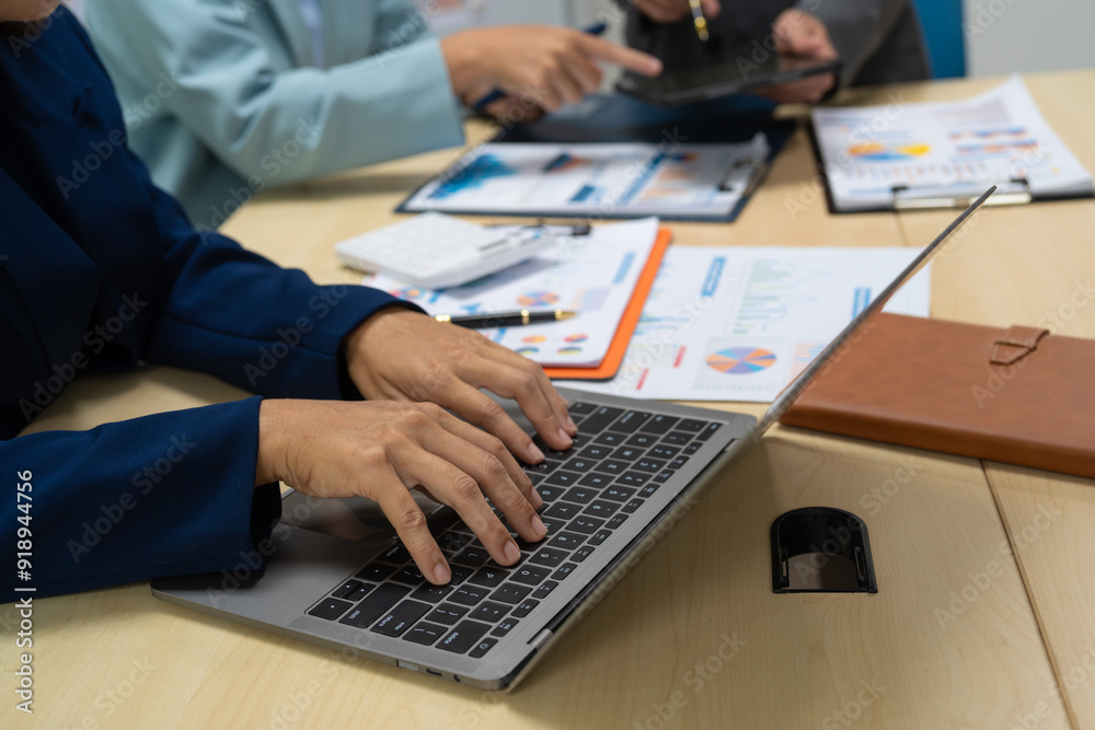 A businessperson financial analyst during a corporate meeting. review a graph document, discussing financial data and strategies to ensure successful outcomes effective teamwork achieving corporate A businessperson financial analyst during a corporate meeting. review a graph document, discussing financial data and strategies to ensure successful outcomes effective teamwork achieving corporate