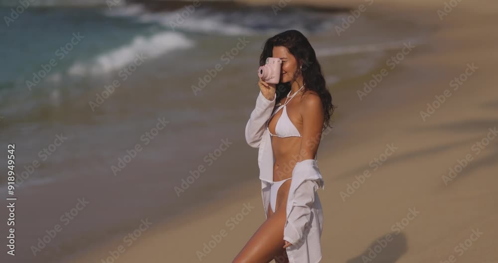 Woman Capturing Vacation Memories on a Tropical Beach with Camera