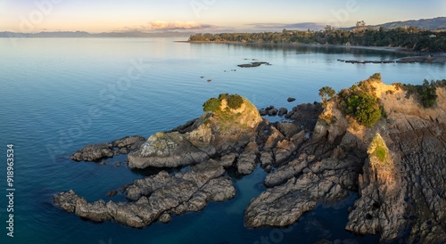 Shoreline of the Firth of Thames at sunset at Orere Point, Auckland, New Zealand.