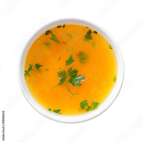 Isolated Bowl of Delicious Yellow Soup with Fresh Herbs.