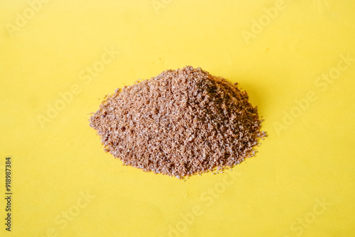 Bubuk ketumbar or coriander powder isolated on yellow background photo