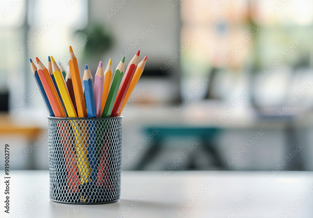 Colorful pencils standing in metal container on blurred background Colorful pencils standing in metal container on blurred background