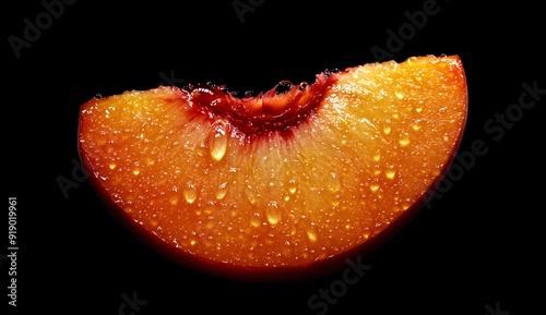 Close up of a juicy peach half with water drops isolated on a black background, high definition. photo