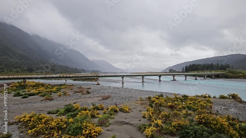 4K, Tranzalpine train journey New Zealand, glacier glacial braided river, mountains clouds and rain, tourist tourism travel journey destination