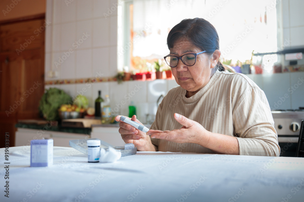 Elderly woman checking blood sugar level at home Elderly woman checking blood sugar level at home