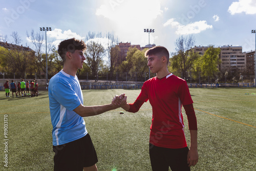 Soccer players wishing luck to each other on field photo