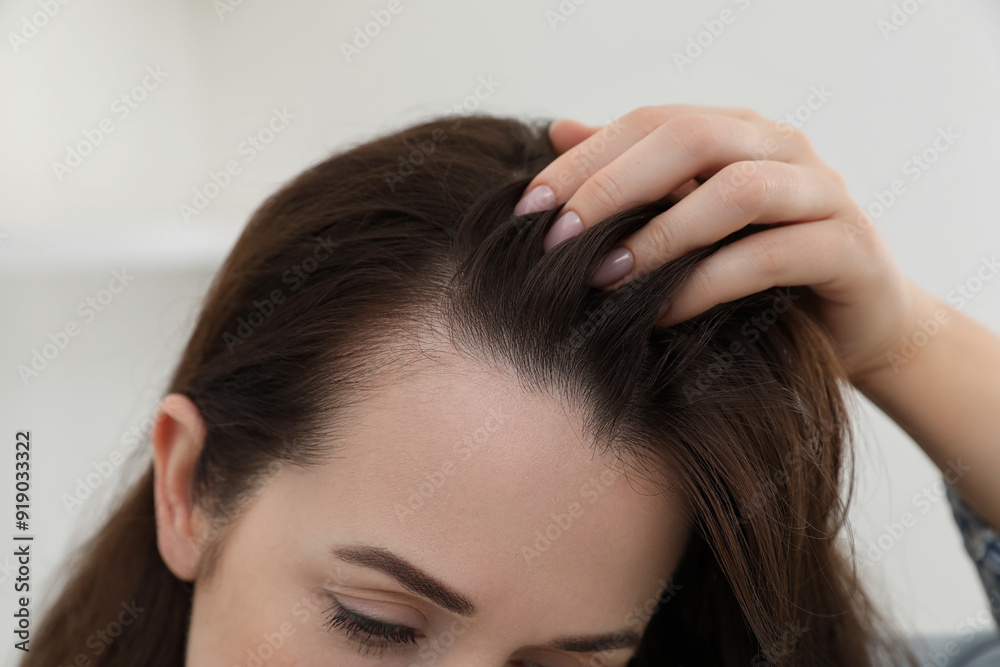 Woman with hair loss problem at home, closeup
