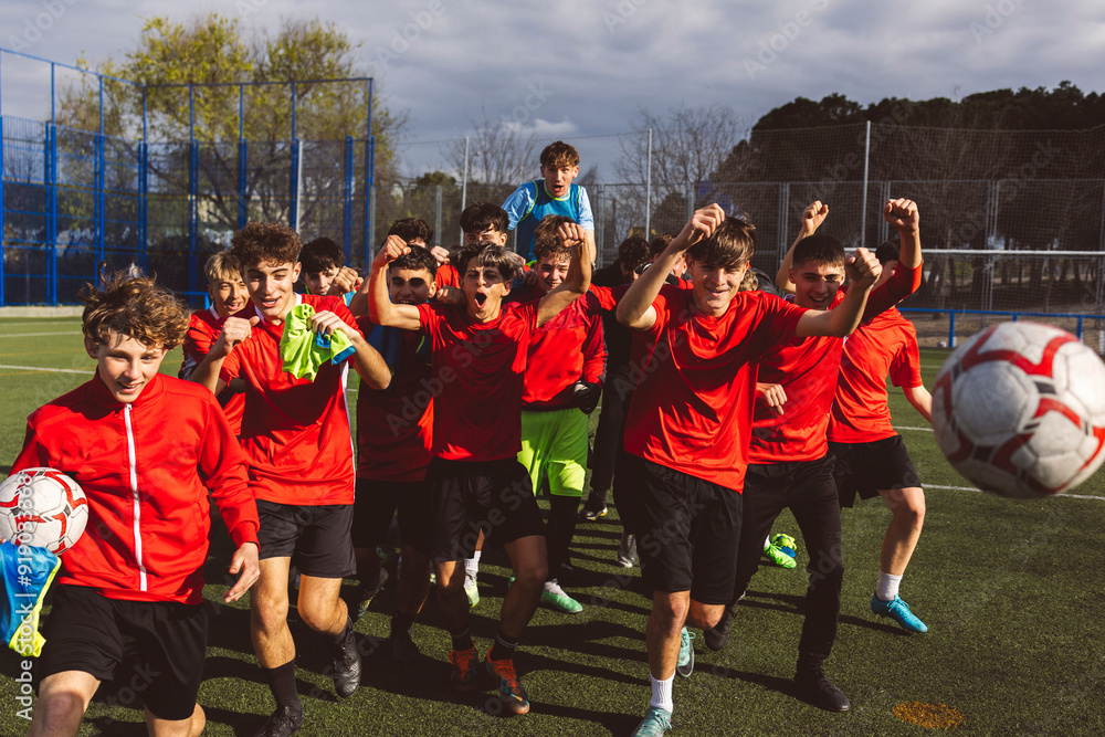 Happy soccer team winning match on sunny day Happy soccer team winning match on sunny day