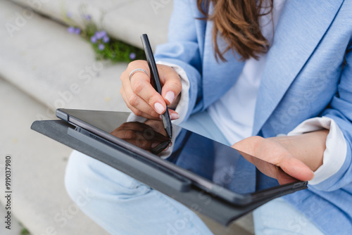 Hand of businesswoman using digitized pen on tablet PC photo