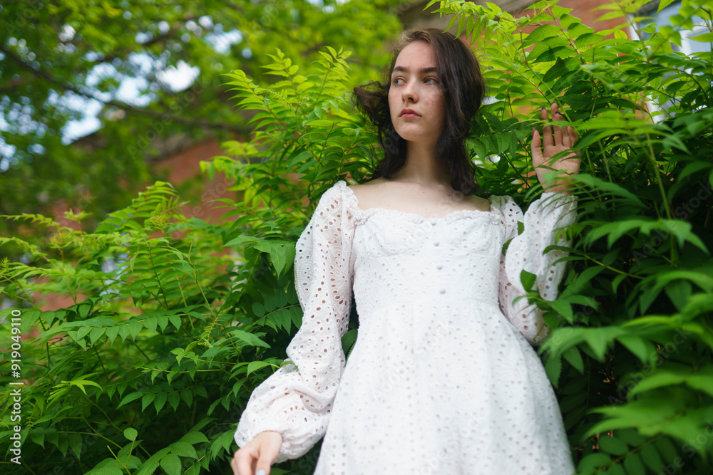 Girl standing between plants in garden