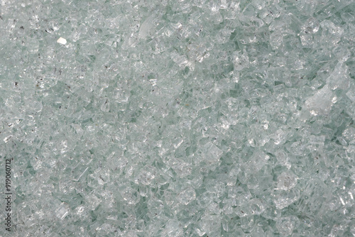 A detailed texture of crushed, transparent glass pieces, showcasing the sharp, jagged edges and varying shapes. photo