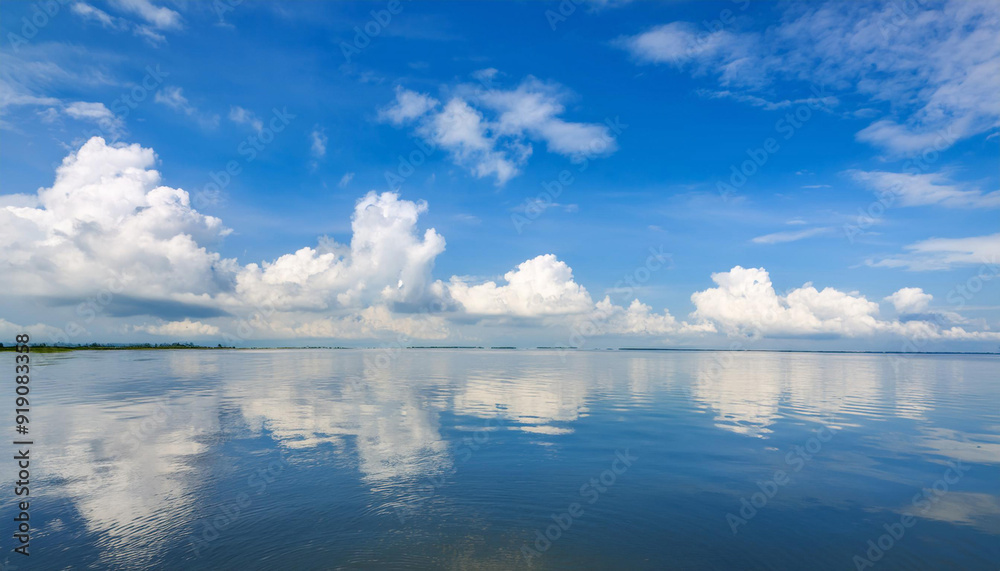 Obraz premium Blue Sky and Clouds Reflecting in Water and Copy Space