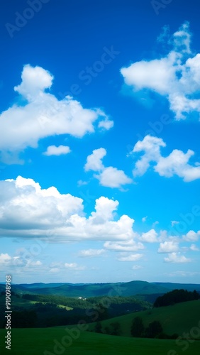 Peaceful Countryside Under Expansive Blue Sky with Serene White Clouds