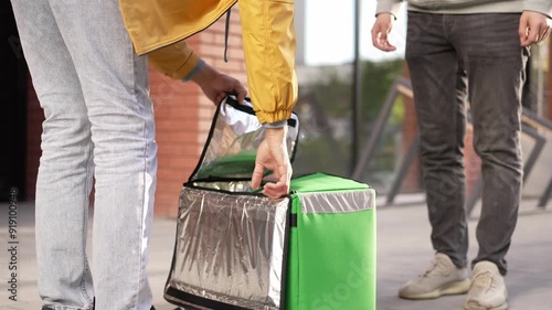 Courier man carry package give bags. Guy walk city street deliver box. Green backpack mock up. Fast food delivery service. Person with thermal store bag. Express home order Picked up groceries product