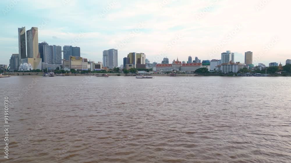 Drone view of Phnom Penh boat tours on Mekong River with city skyline buildings in view