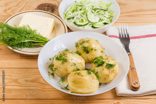 Boiled young potatoes and vegetable salad, dill and butter separatelly