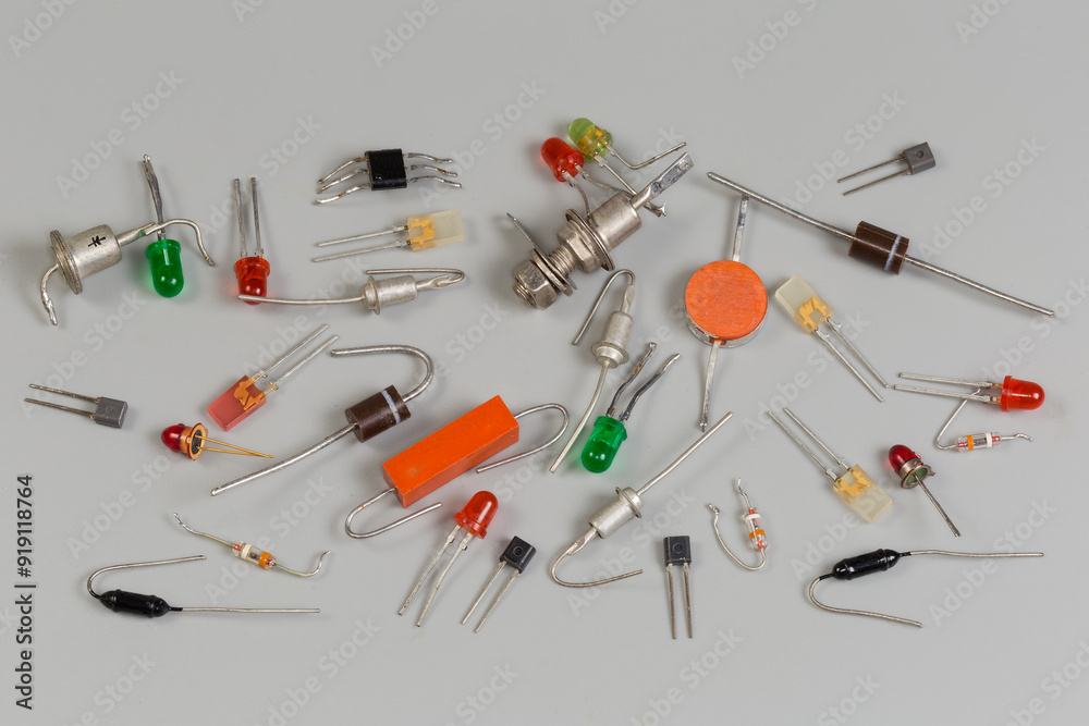 Different old semiconductor diodes in various packages on gray surface Different old semiconductor diodes in various packages on gray surface
