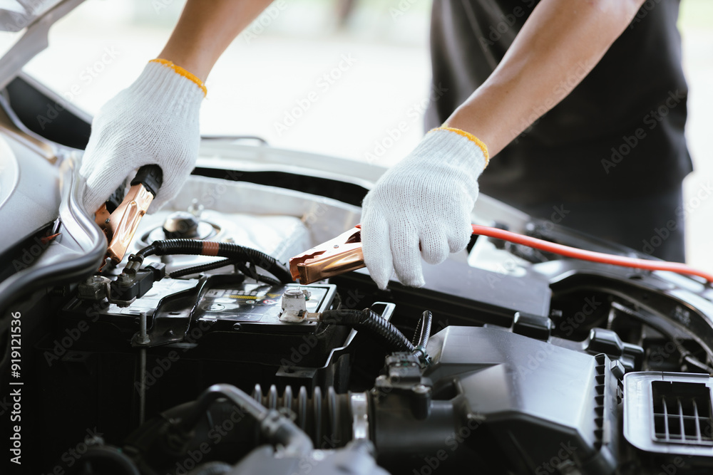 A male motor mechanic stands in a workshop, performing a safety inspection on a car engine. Surrounded by tools and equipment, he diagnoses and repairs vehicle issues. A male motor mechanic stands in a workshop, performing a safety inspection on a car engine. Surrounded by tools and equipment, he diagnoses and repairs vehicle issues.