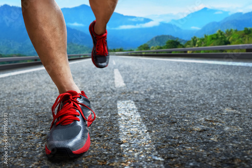 Closeup of young man legs running on the street in the morning