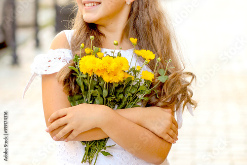 Banner with a cute Caucasian girl with a smile and a bouquet of yellow flowers. Floristry concept.