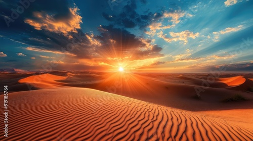 Vast desert landscape with rolling sand dunes under a dramatic sunset sky