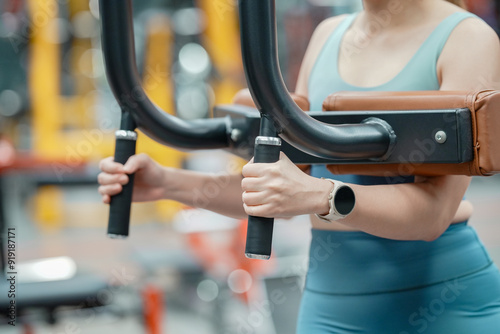 Close up of female hand with smart watches doing exercises in fitness gym.