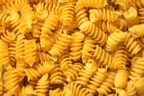 Pile of raw fusilli pasta close-up. Italian pasta, pasta cones texture, top view