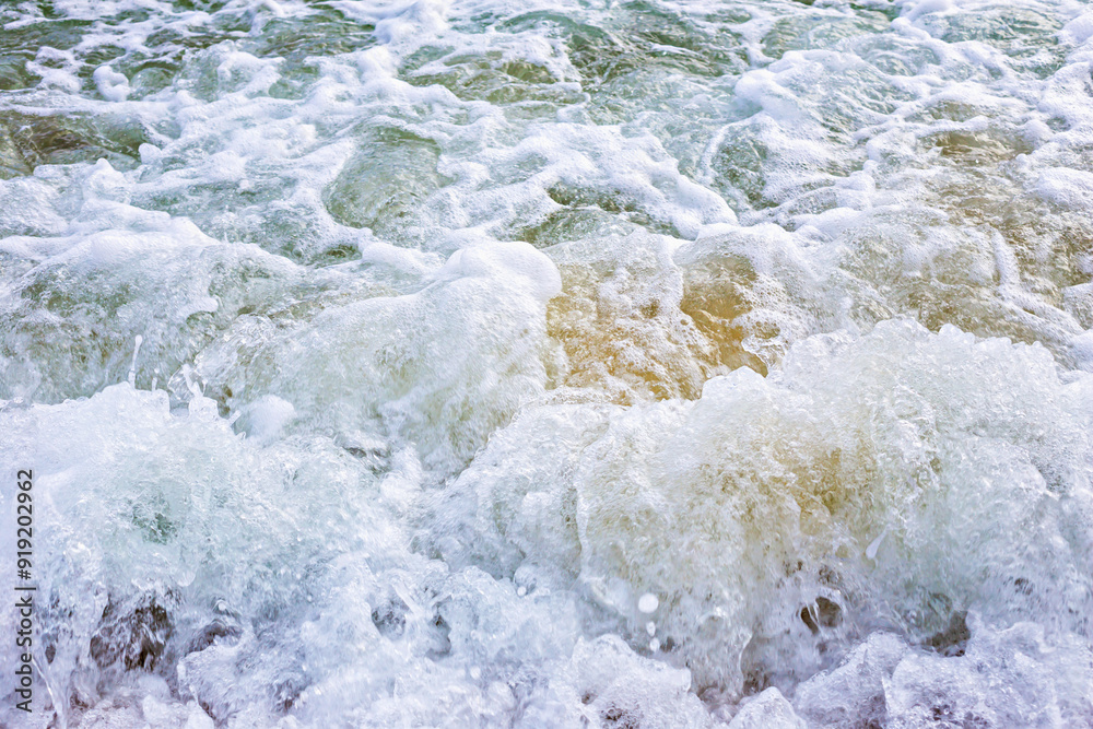 Close-up of turbulent, frothy sea waves, capturing intense movement and natural beauty of ocean. Selective focus, defocus