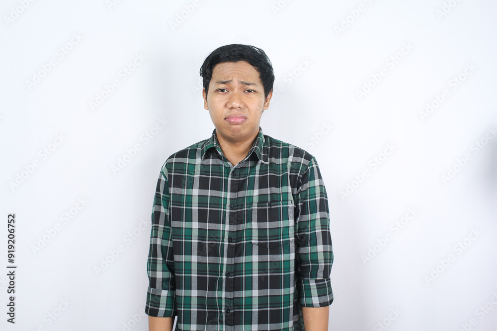 sorrowful handsome asian man with sad expression feeling hopeless and desperate isolated sorrowful handsome asian man with sad expression feeling hopeless and desperate isolated