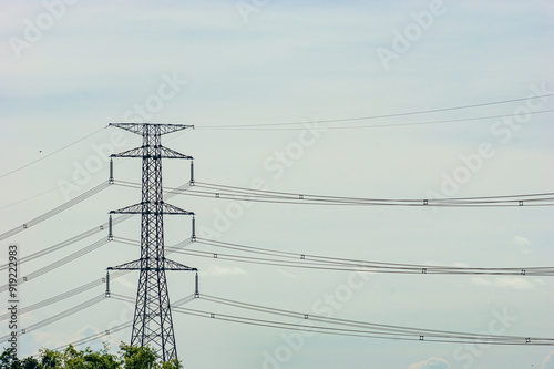 Electric poles and lines or high voltage towers at beautiful sky
