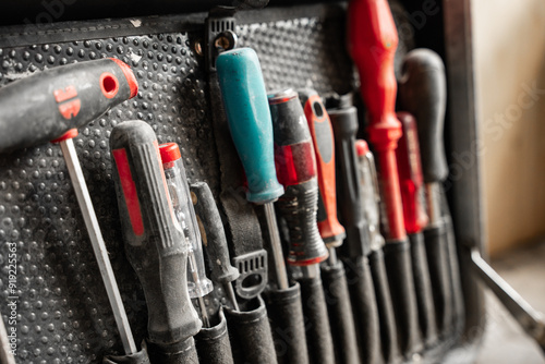 Foto Various Work Tools In Little Black Toolbox. Equipment.