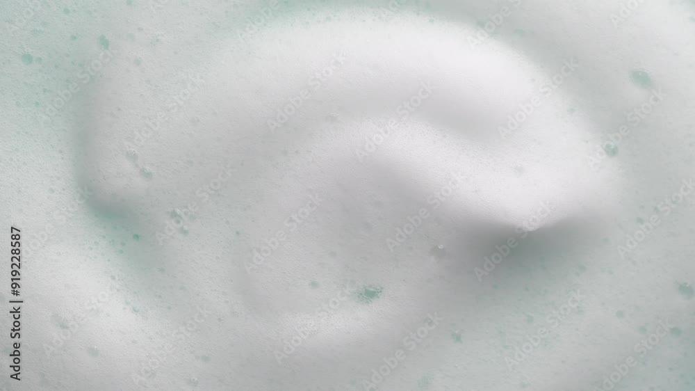 Foam texture swirl backdrop. Liquid soap bubbles background, Froth bubbles backdrop. Soap foam popping bubble rotating. Soap sud macro structure close-up. Clean, cleaning, washing, laundry