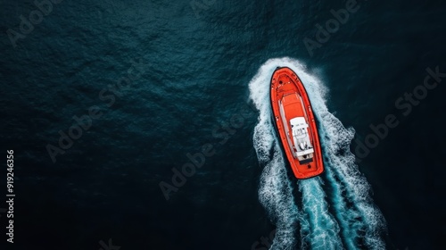 A dynamic aerial view of a red motorboat navigating through the deep blue ocean, highlighting human exploration, energy, and captivating sea adventures. photo