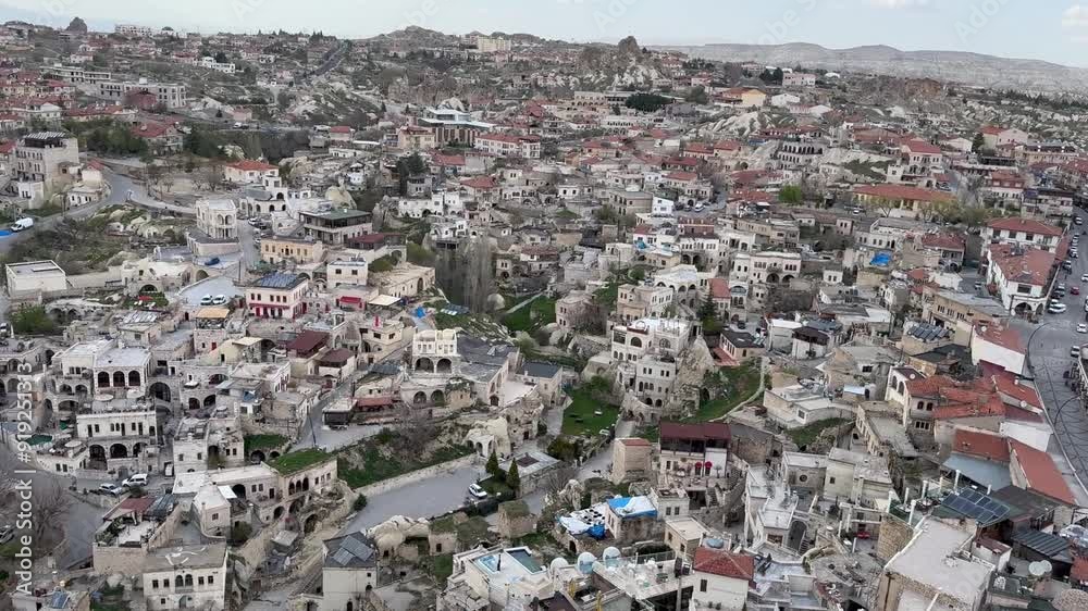 Cappadocia, Turkey -24 April 2024, View of the town of Ortahisar with the minaret of the mosque in the foreground and the valley of Cappadocia in the background near the town of Goreme, Cappadocia, Turkey -24 April 2024, View of the town of Ortahisar with the minaret of the mosque in the foreground and the valley of Cappadocia in the background near the town of Goreme,