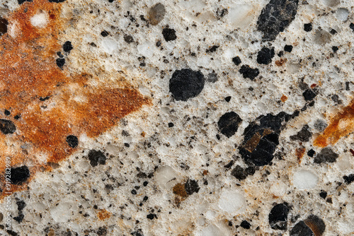 A polished granite surface with speckled patterns in various shades, giving a solid and refined appearance,
