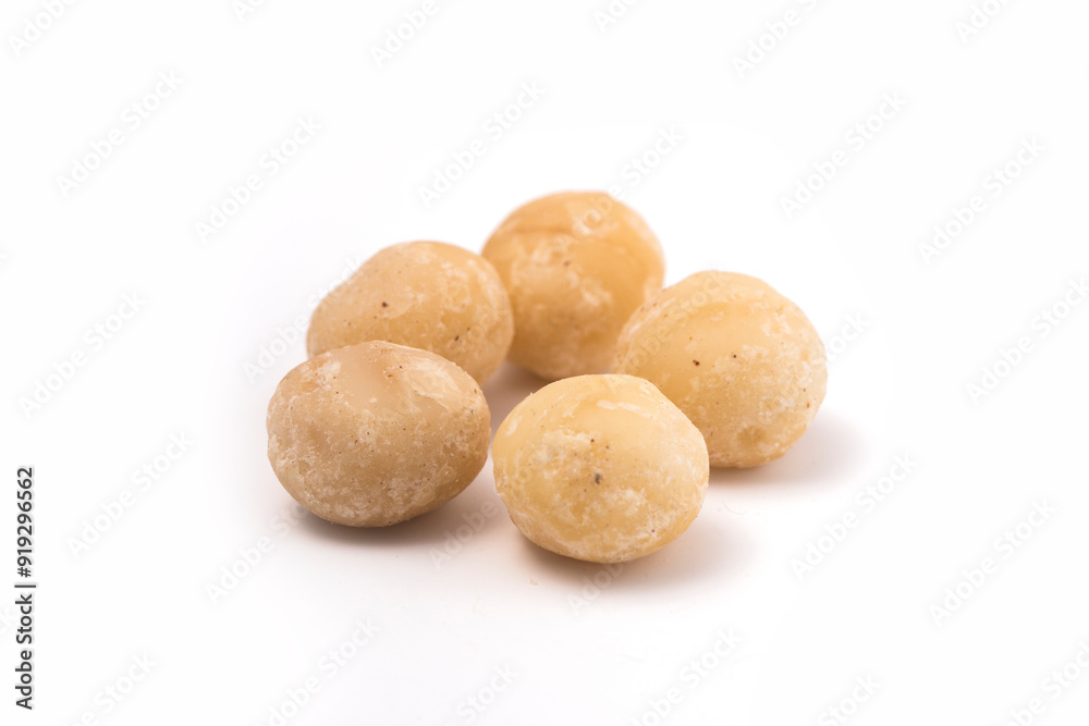 Macadamia nuts on white background. Selective focus with shallow depth of field. Macadamia nuts on white background. Selective focus with shallow depth of field.