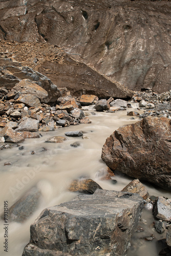 Melt waters of the Becho Glacier. Water flowing from the glacier on Ushba mountain. 
Dolra River in Becho Valley with panoramic views of Ushba Mountain. River photos taken with long exposure. photo