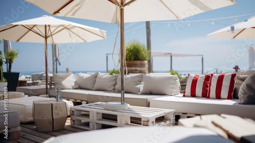 Terrace on the roof of the house with white umbrellas on the sea background