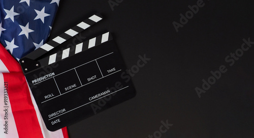 Clapper board and Usa flag on black background.