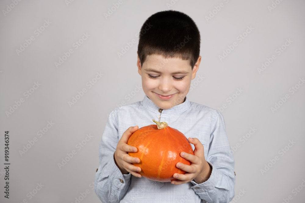 Cute happy child with small Hokkaido pumpkin on white background. Cute happy child with small Hokkaido pumpkin on white background.