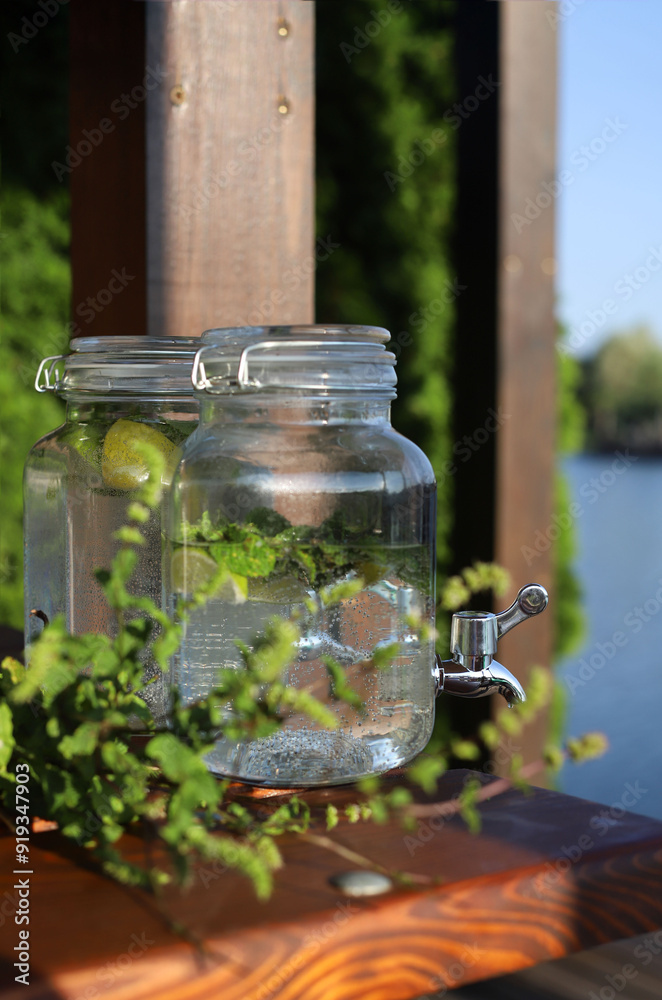 refreshing summer drink lemonade in glass jars with tap. refreshing summer drink lemonade in glass jars with tap.