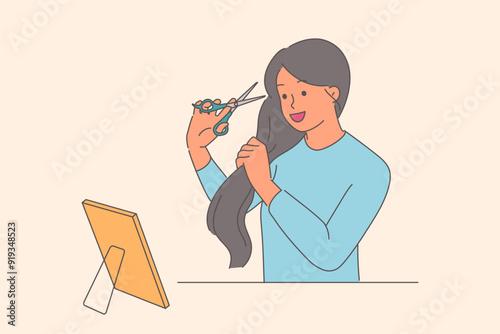 Woman cuts hair, wanting to change hairstyle without going to hairdresser, stands near mirror