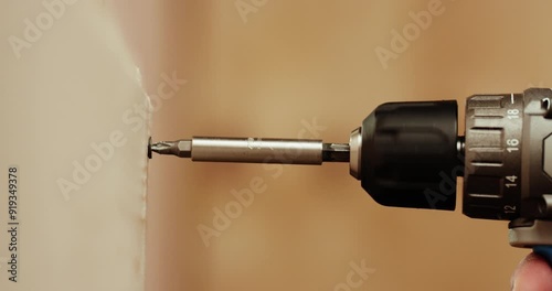 Close-up of a screwdriver to screw.