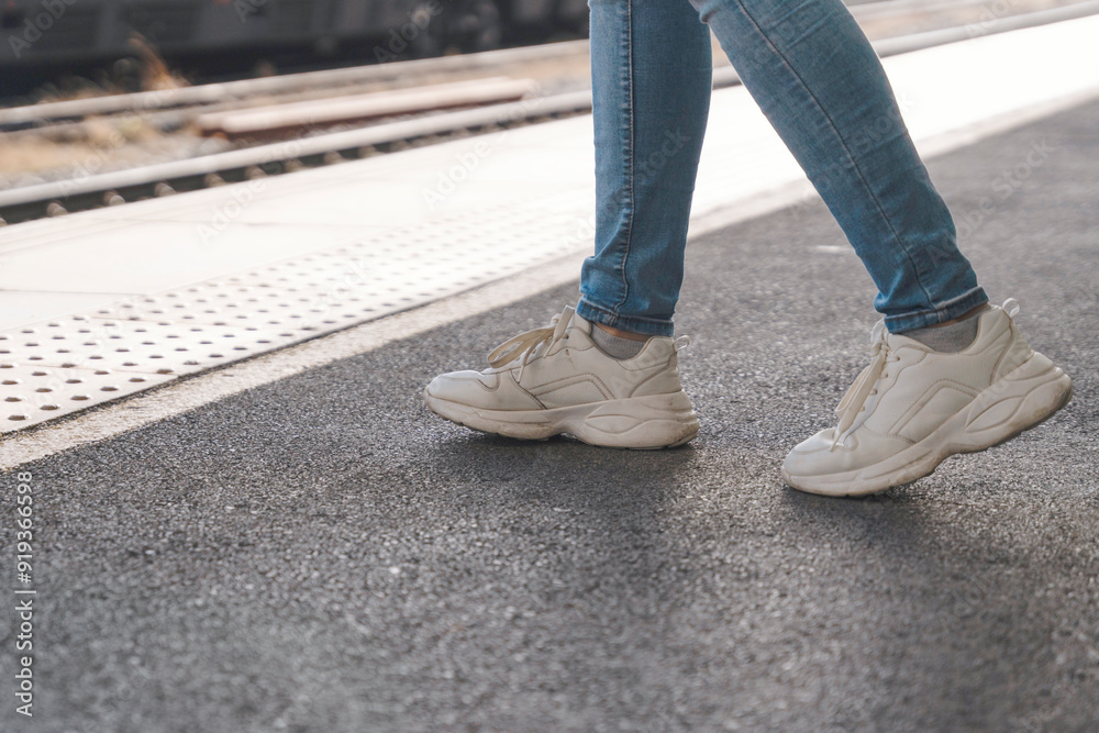 journey begins at train station platform during sunny afternoon with casual sneakers guiding way journey begins at train station platform during sunny afternoon with casual sneakers guiding way