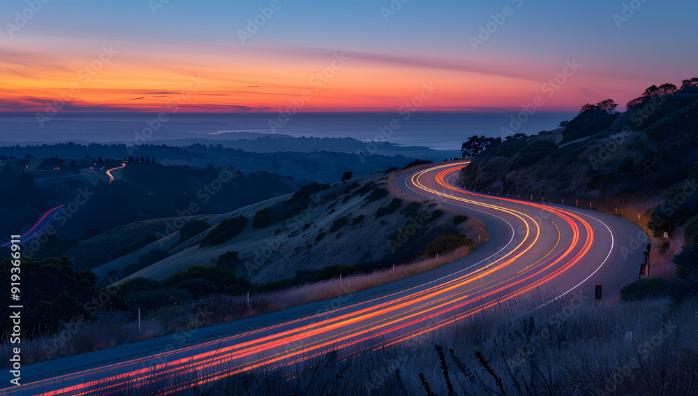 A long exposure photo of a highway at sunset, with light trails from cars creating streaks across the horizon. The road leads into the distance, with hills in the background, evoking a sense of speed. A long exposure photo of a highway at sunset, with light trails from cars creating streaks across the horizon. The road leads into the distance, with hills in the background, evoking a sense of speed.